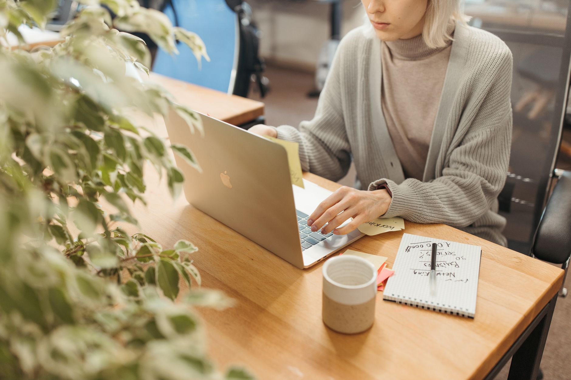 a person reading a job listing on a laptop at a home desk
