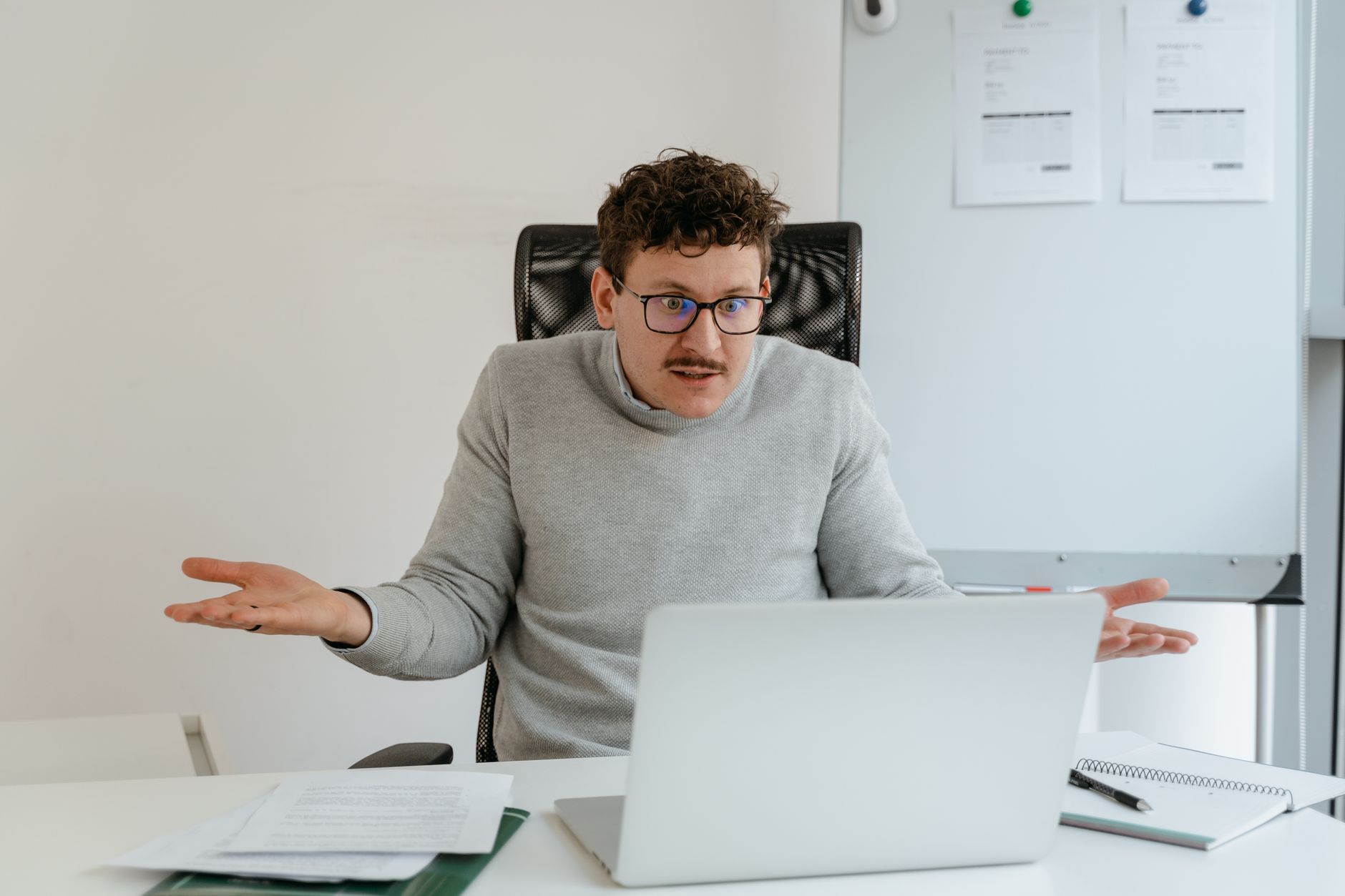 a job seeker looking confused during a video call interview on a laptop